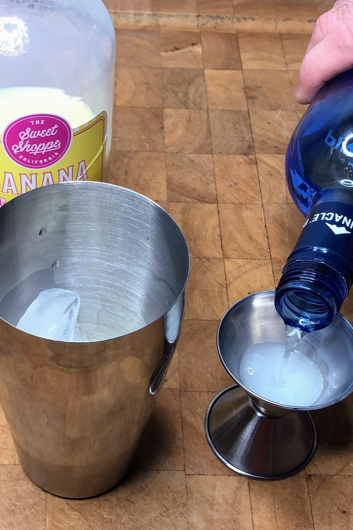 Pouring whipped cream vodka into jigger.