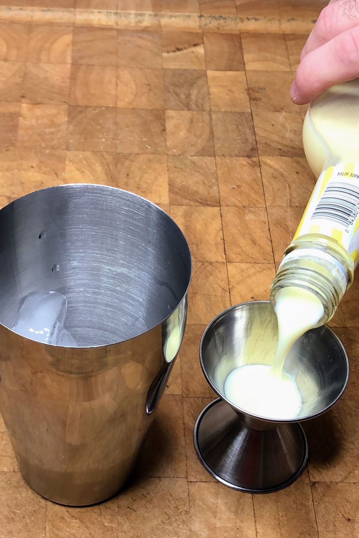Pouring banana liquer into jigger.