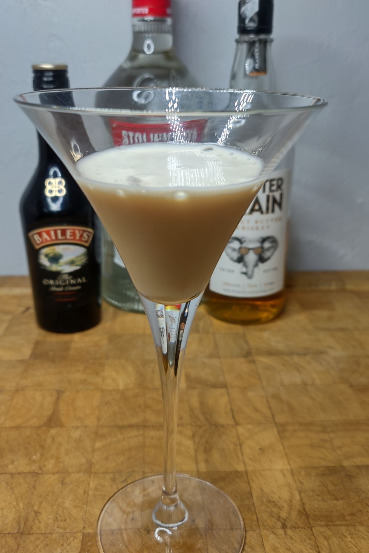 Peanut butter martini on a wooden table.